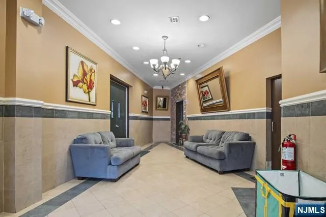 a living room with furniture and a chandelier