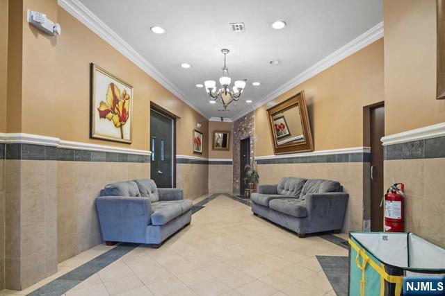 15-19 Tichenor Lane, Unit 404 Newark, NJ 07114 - Photo 18 of 22 a living room with furniture and a chandelier