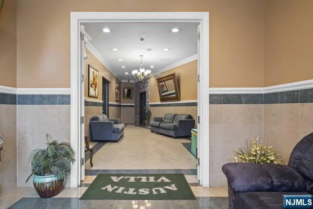 a view of a livingroom and a dining room with furniture wooden floor and a chandelier