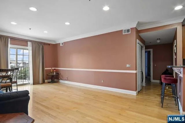 a bedroom with furniture and a large window