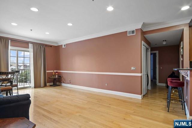 15-19 Tichenor Lane, Unit 404 Newark, NJ 07114 - Photo 6 of 22 a bedroom with furniture and a large window