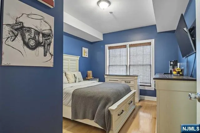 a bed room with a bed and a television