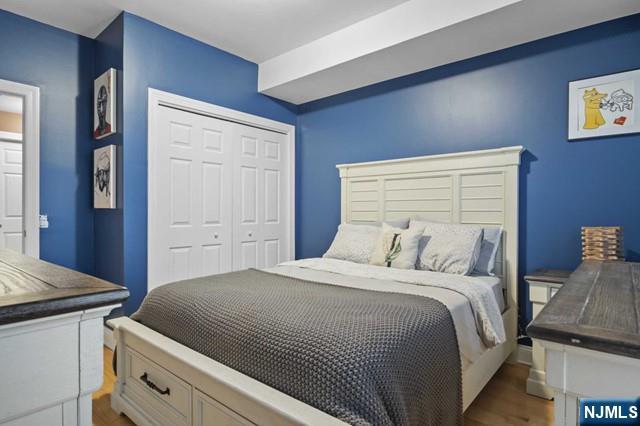 15-19 Tichenor Lane, Unit 404 Newark, NJ 07114 - Photo 8 of 22 a bedroom with a bed and a cabinets