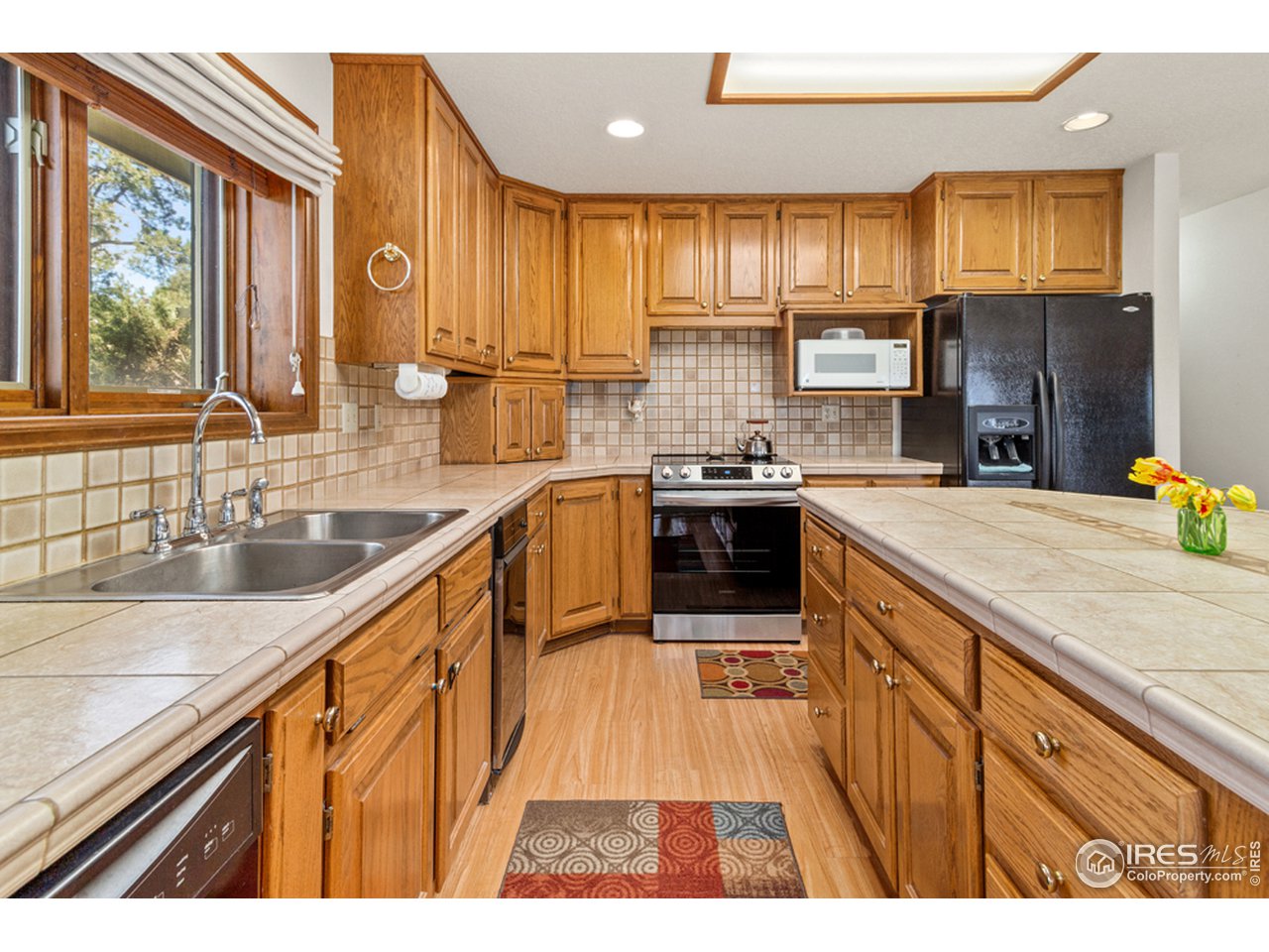 11900 Rist Canyon Road Bellvue, CO 80512 - Photo 11 of 34 a kitchen with stainless steel appliances granite countertop a sink stove and cabinets