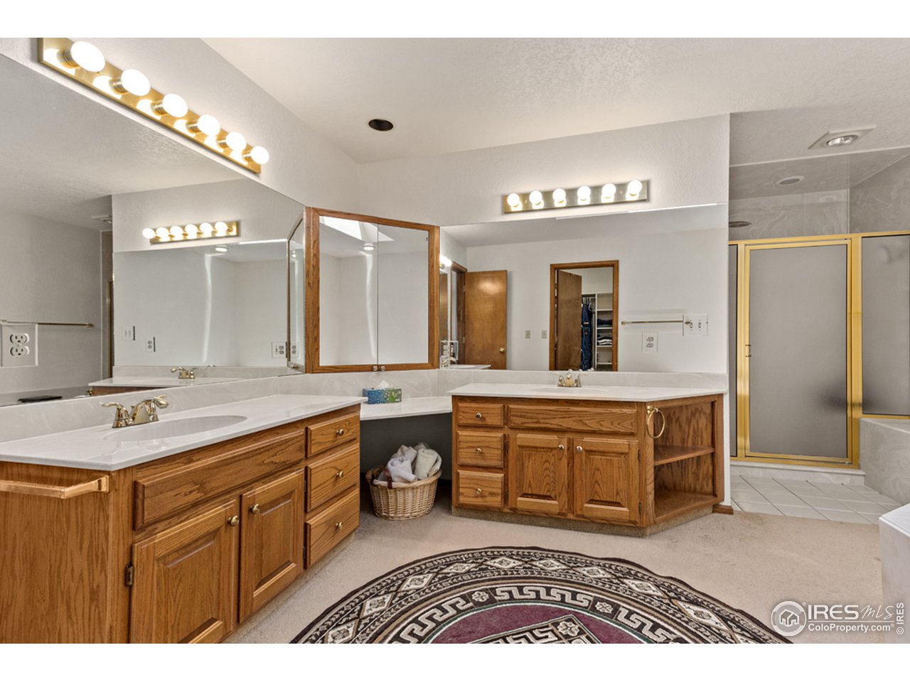 11900 Rist Canyon Road Bellvue, CO 80512 - Photo 18 of 34 a spacious bathroom with a granite countertop double vanity sink a mirror and a bathtub