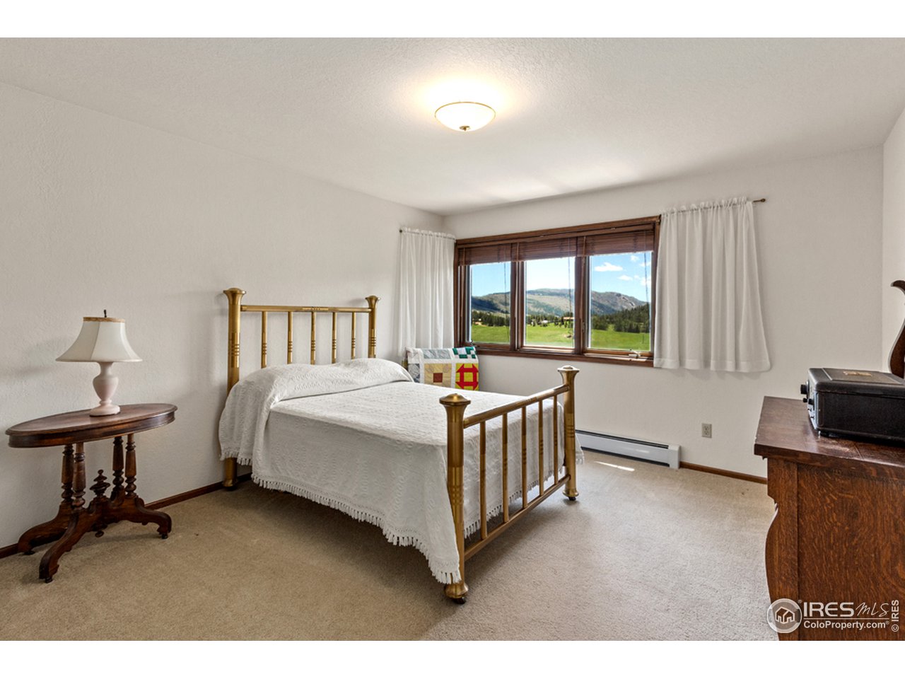11900 Rist Canyon Road Bellvue, CO 80512 - Photo 21 of 34 a bedroom with a bed and a night stand