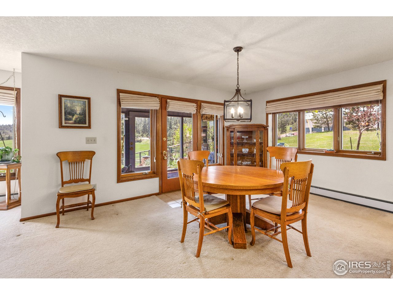 11900 Rist Canyon Road Bellvue, CO 80512 - Photo 7 of 34 a dining room with furniture a chandelier and wooden floor