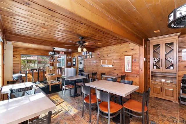 a kitchen with refrigerator and chairs