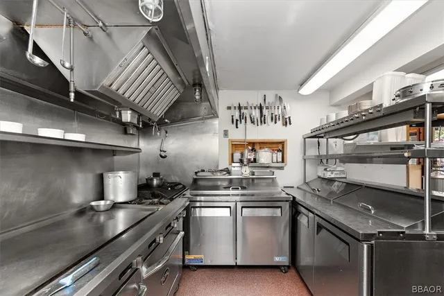 a kitchen with granite countertop a stove and a shower