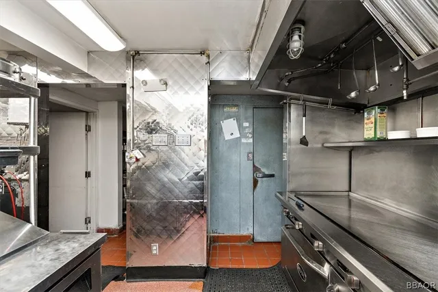 a kitchen with stainless steel appliances granite countertop a sink a stove and a counter space