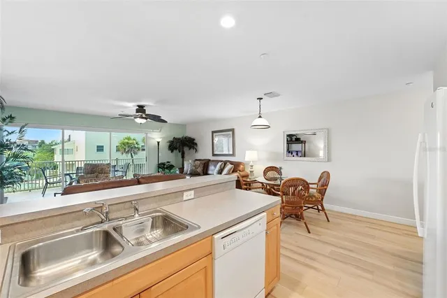 a view of a kitchen with dining table and chairs