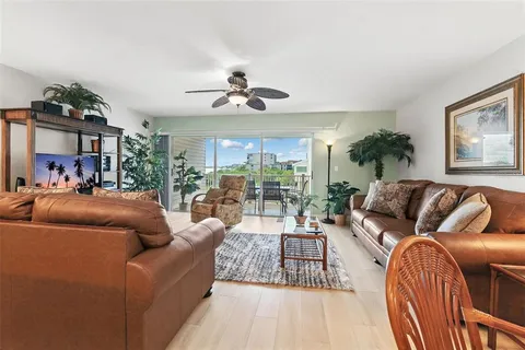 a living room with furniture ceiling fan and a rug