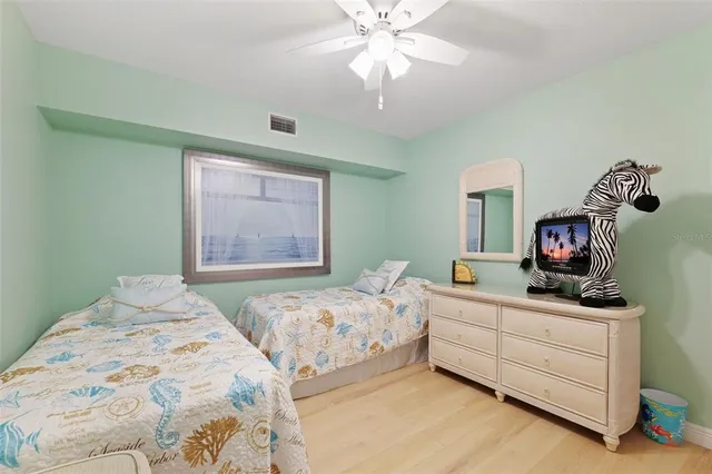 a bedroom with a bed and a tv on the dresser