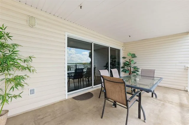 a view of a porch with furniture and floor to ceiling window