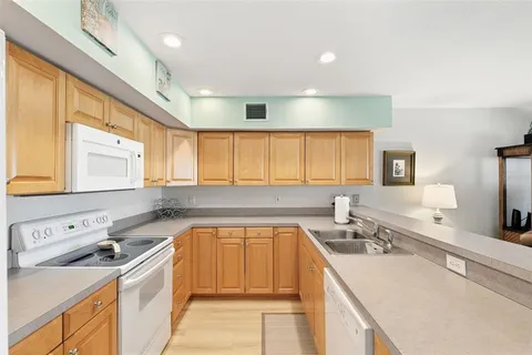 a kitchen with a sink stove and cabinets
