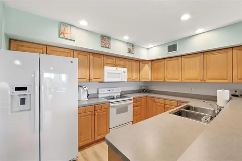 a kitchen with a sink a stove and cabinets