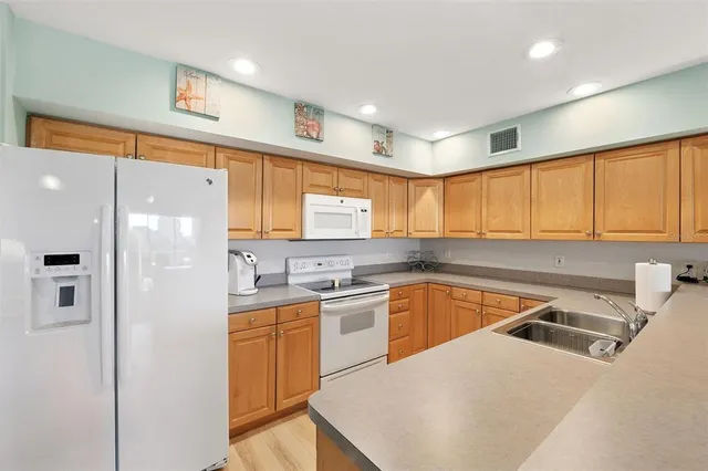 a kitchen with a sink a stove and cabinets