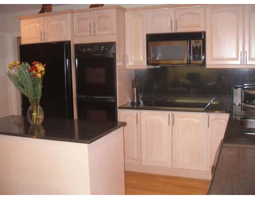 71 Cynthia Road Newton, MA 02459 - Photo 3 of 12 a kitchen with a refrigerator and cabinets