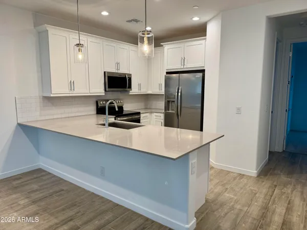 a palm tree sitting in a yard with a palm trees