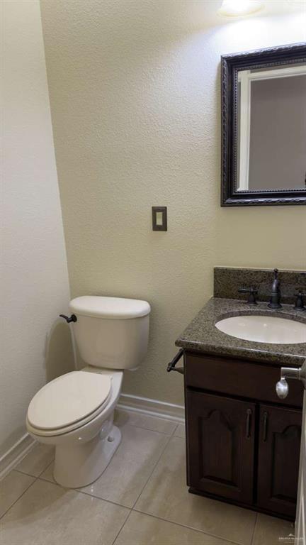 2104 Foggy Loop Laredo, TX 78045 - Photo 12 of 23 a bathroom with a granite countertop toilet sink and mirror