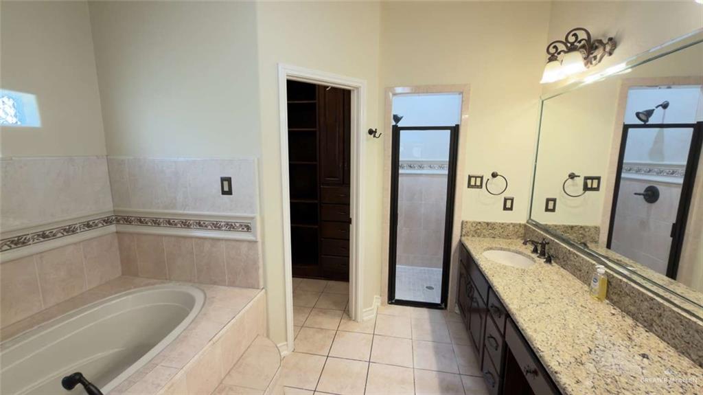 2104 Foggy Loop Laredo, TX 78045 - Photo 14 of 23 a spacious bathroom with a granite countertop tub sink and mirror