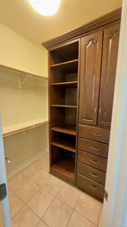 a view of walk in closet with empty racks