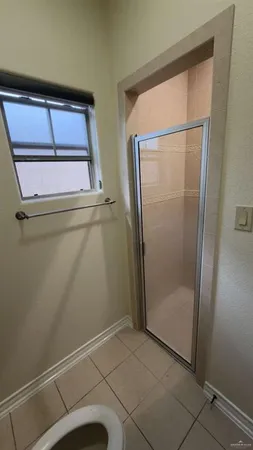 a bathroom with a glass shower door