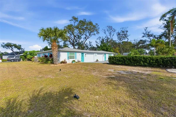 a front view of a house with a yard and mountain view