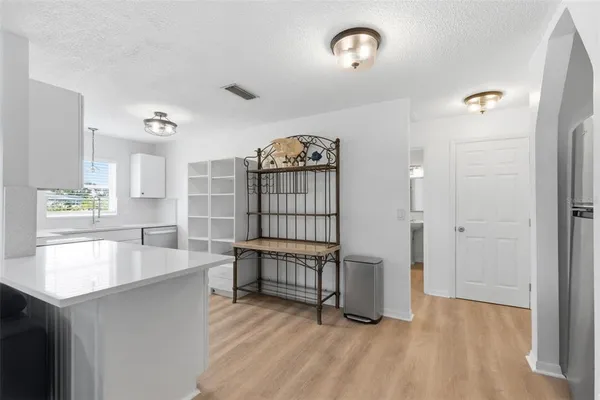 a view of kitchen with furniture and wooden floor