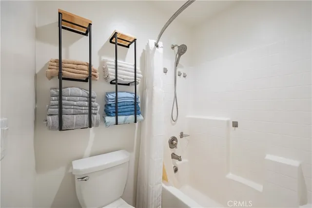 a bathroom with a shower a toilet and a shower