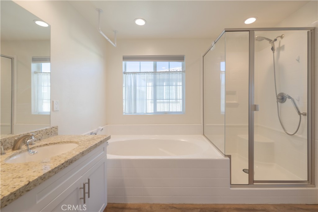 4244 Bravado Riverside, CA 92505 - Photo 15 of 25 a bathroom with a granite countertop sink a mirror and a bathtub