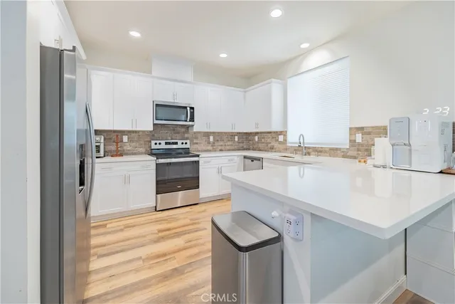 a kitchen with stainless steel appliances granite countertop a sink and cabinets