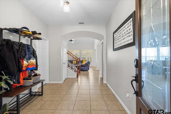 a living room with furniture a rug and a window
