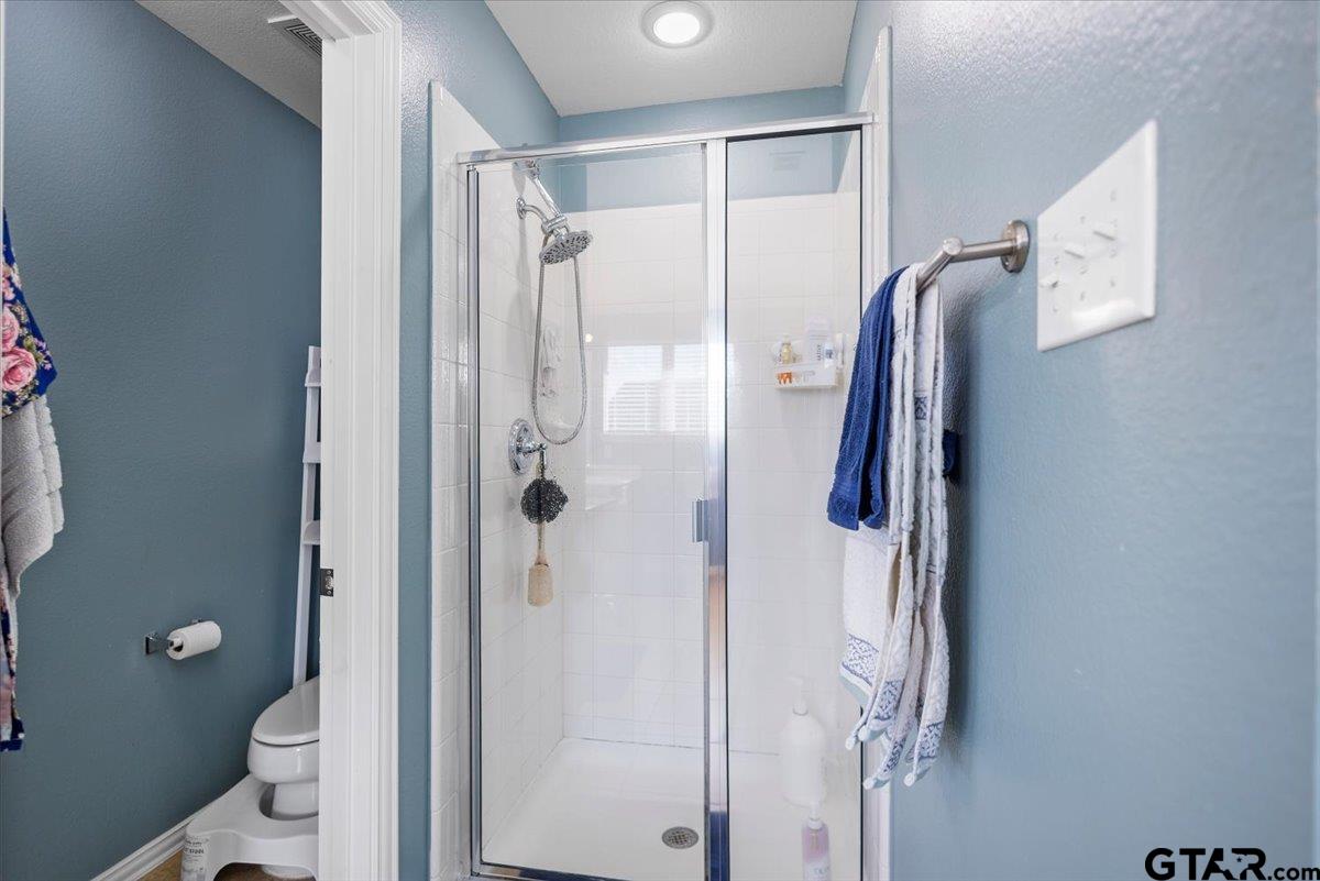 401 Boxwood Trail Forney, TX 75126 - Photo 26 of 45 a bathroom with a shower and a toilet