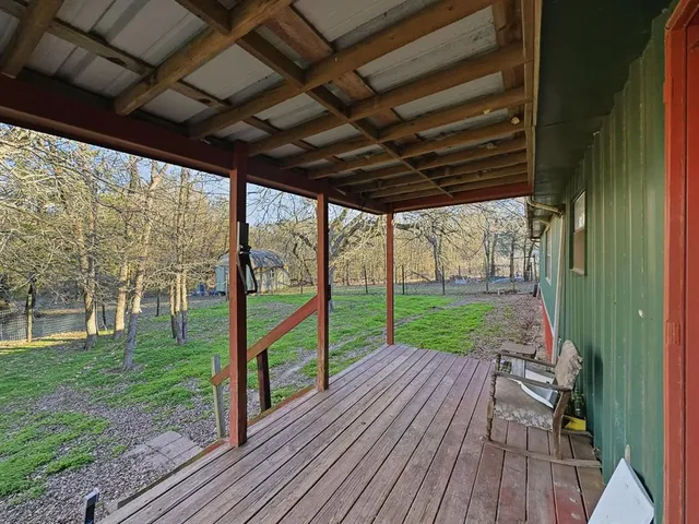 a view of a porch with wooden floor and outdoor space