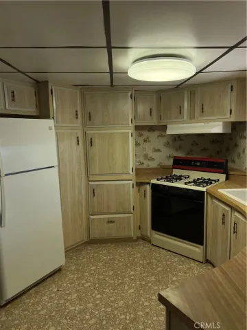 a kitchen with a stove and a refrigerator