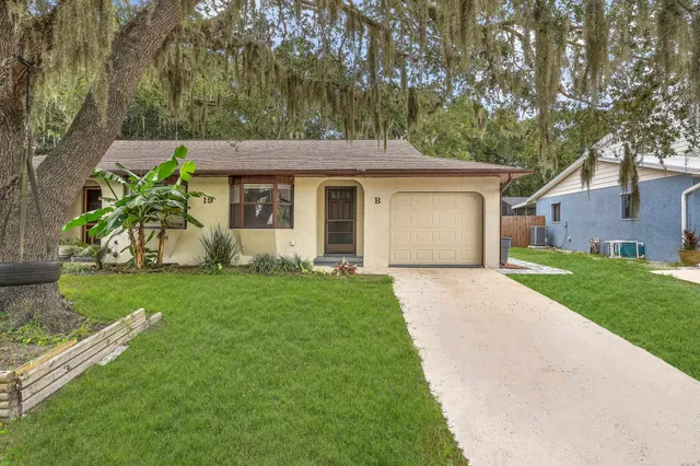 a front view of house with yard and green space