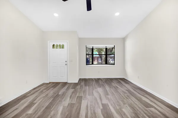 wooden floor in an empty room with a window