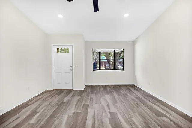 wooden floor in an empty room with a window