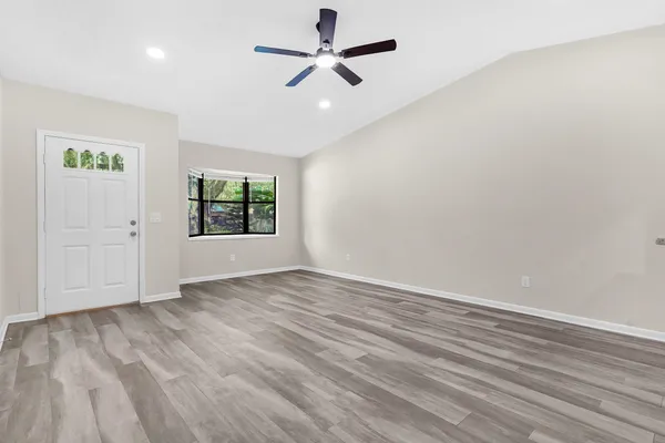 wooden floor in an empty room with a window