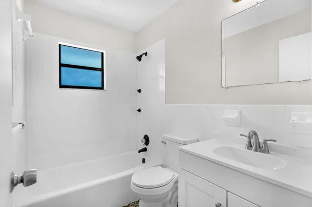 a bathroom with a sink a toilet and a bathtub