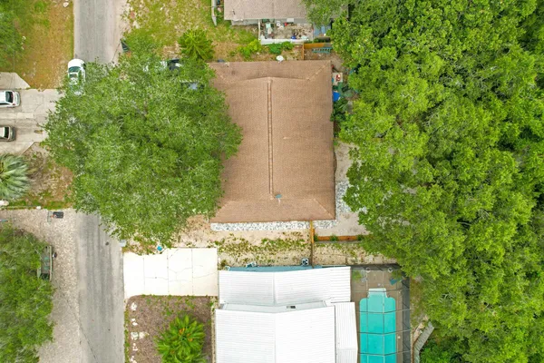 an aerial view of a house with a yard and garden