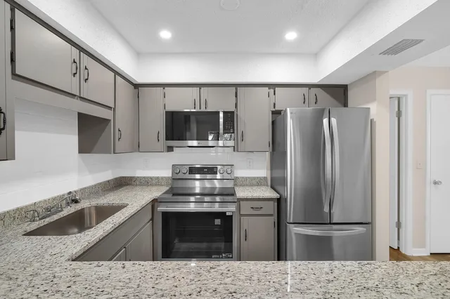 a kitchen with a refrigerator sink and microwave