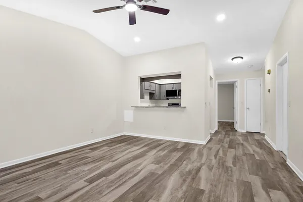 a view of empty room with wooden floor