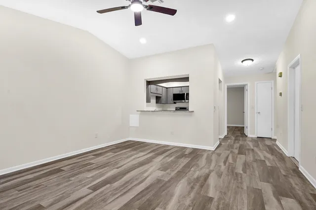 a view of empty room with wooden floor
