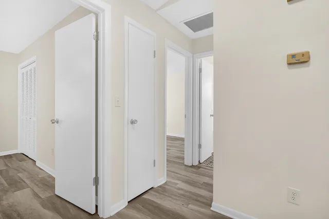 a view of a hallway with wooden floor