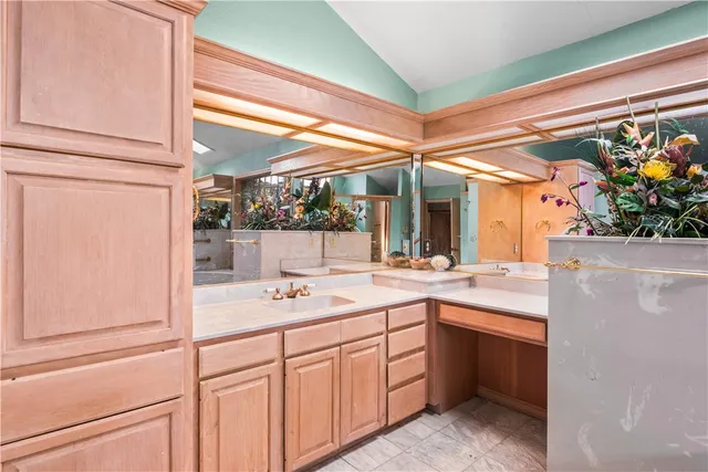 a bathroom with a sink mirror and a bathtub