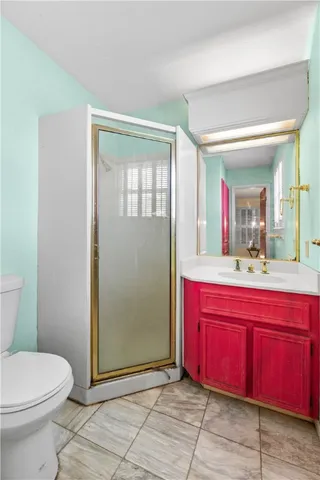 a kitchen with granite countertop a stove a sink and a white cabinets