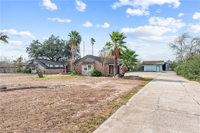 a front view of a house with a yard and a garage