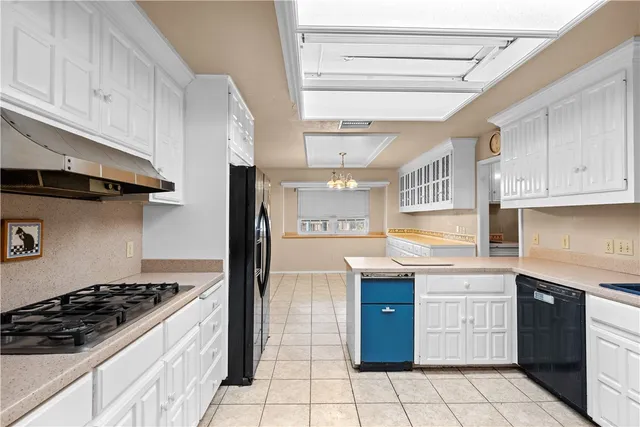 a kitchen with a stove top oven sink and cabinets